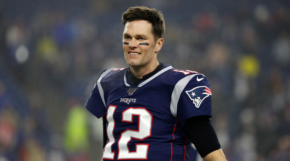 Tom Brady in a Patriots jersey with no helmet on